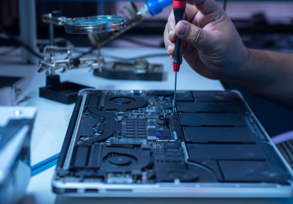 Computer technician fixing the laptop